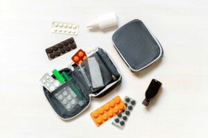 daily medicine chest, container of pills, tablets, vitamins, travel first aid kit. pill box dispenser medications, nutritional supplements. medical treatment for disease virus dosage of medicine