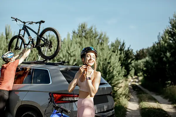 couple with bicycles and car in the forest 2023 11 27 05 06 35 utc