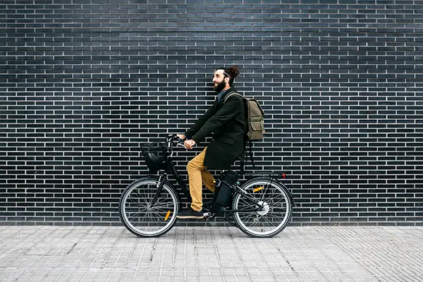 man riding e bike along a brick wall 2023 11 27 05 36 21 utc