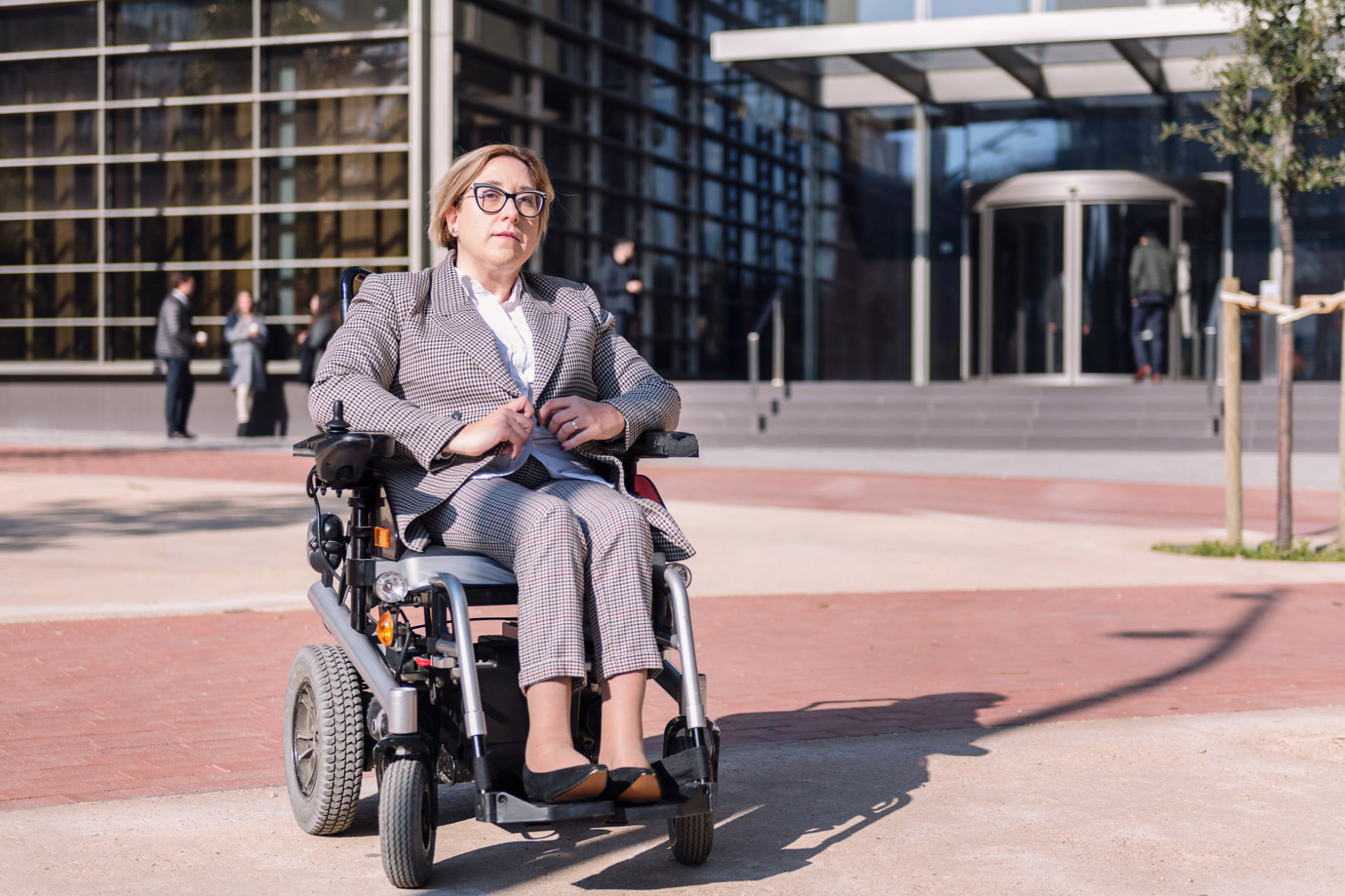 businesswoman using wheelchair at street
