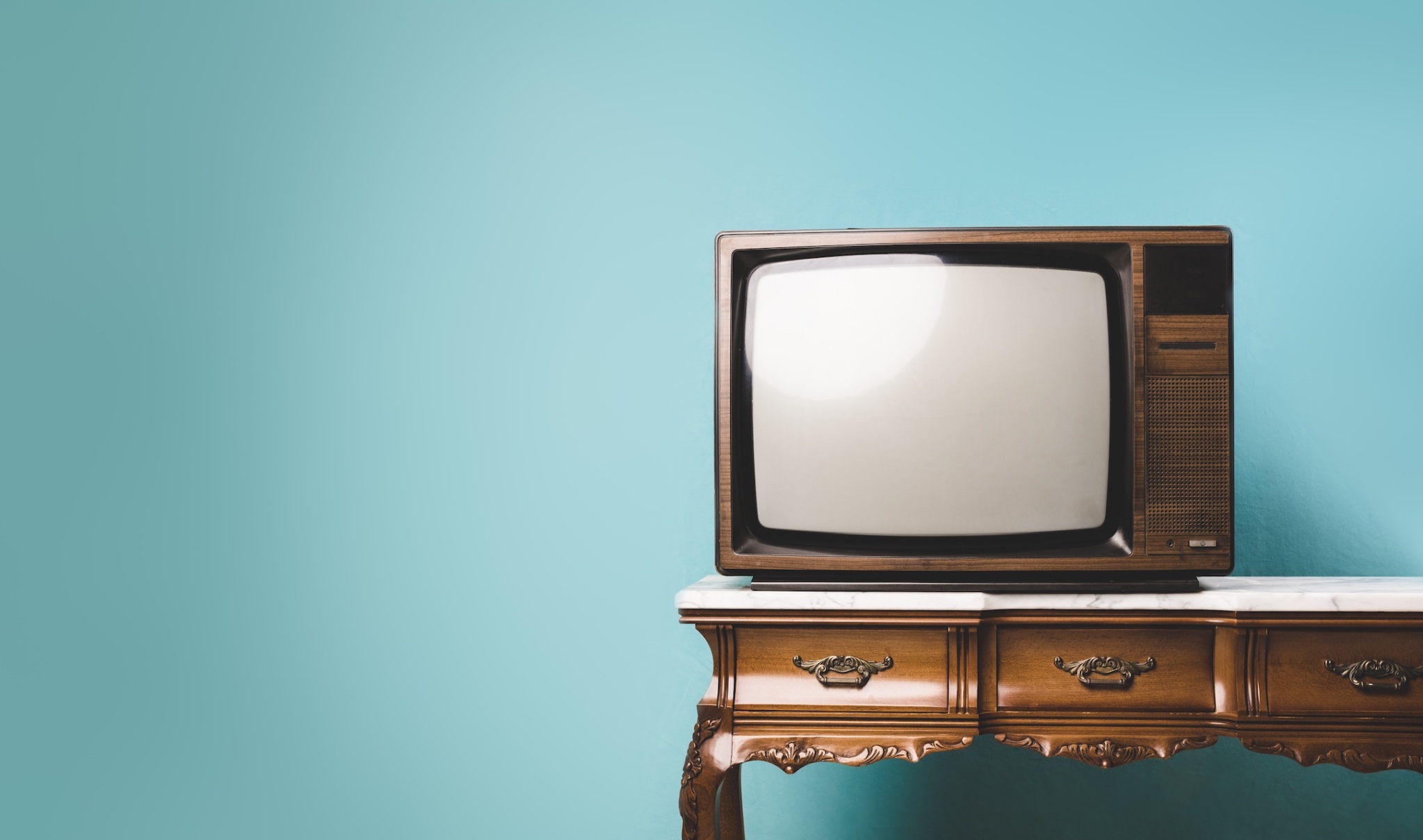 old retro tv on a table over an isolated background.