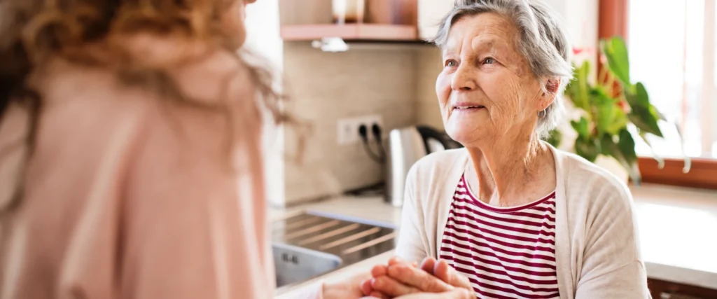 An older woman talking in the kitchen