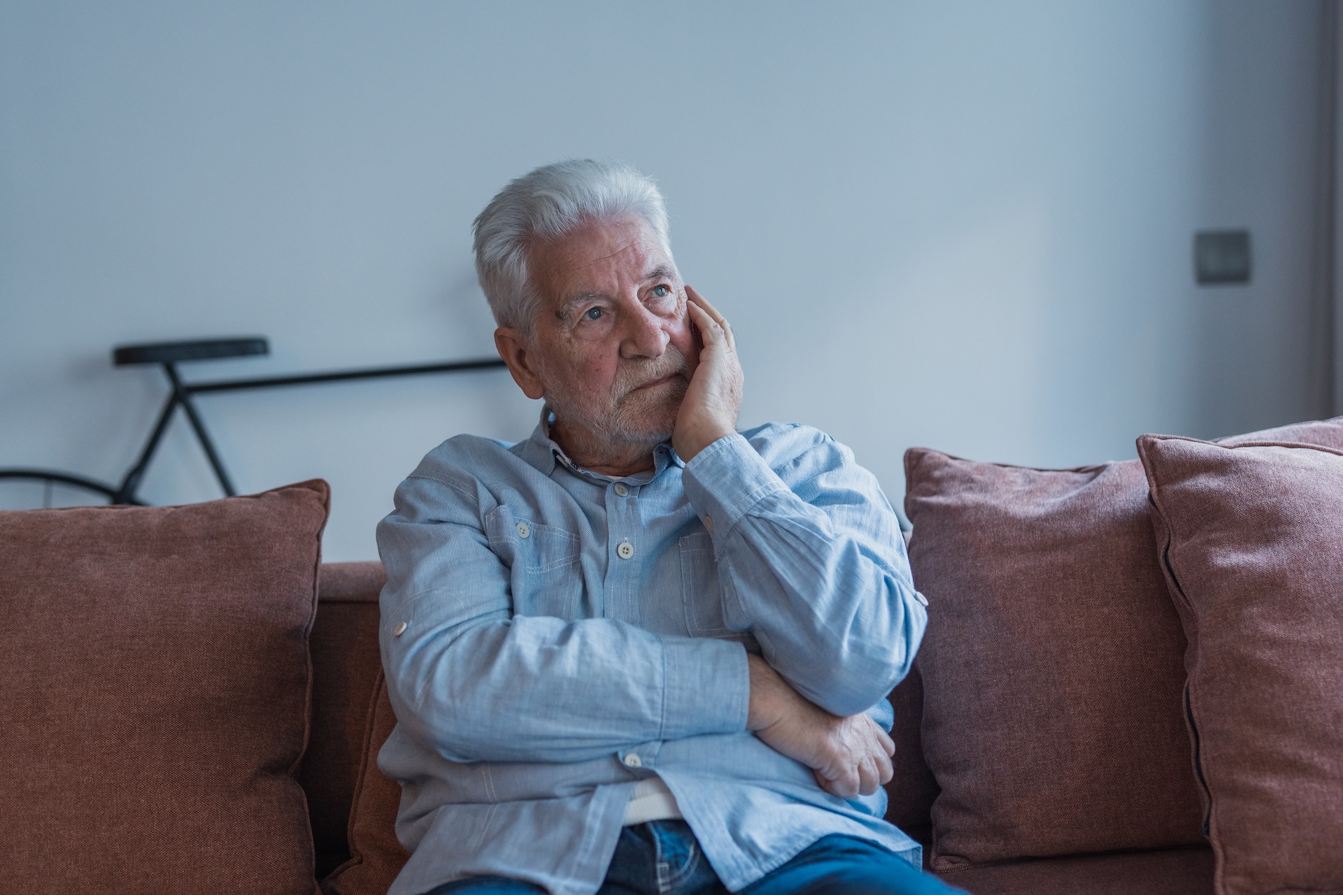 thoughtful senior man sitting on sofa at home 2026 05 25 17 54 44 utc