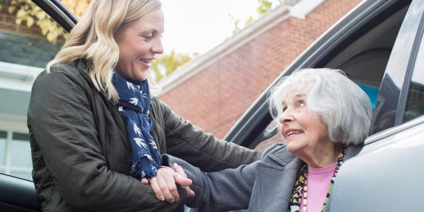 Female Neighbor Giving Senior Woman A Lift In Car