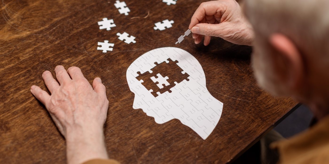 senior completing brain puzzle on wooden table 2026 03 13 01 07 18 utc 2