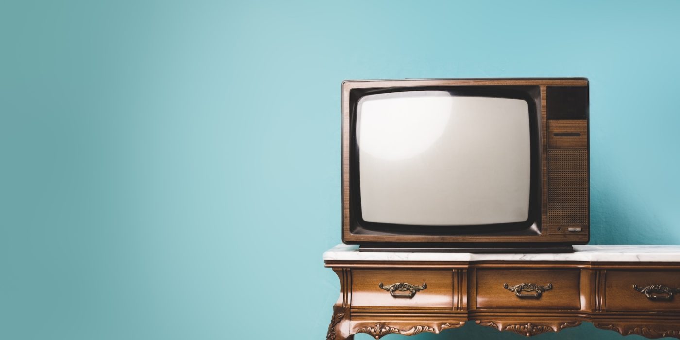 old retro tv on a table over an isolated background.